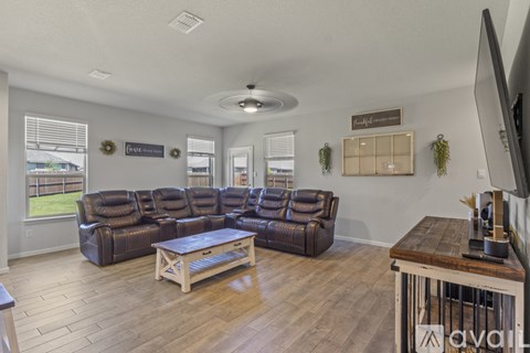 A living room with a large sectional sofa and a coffee table.