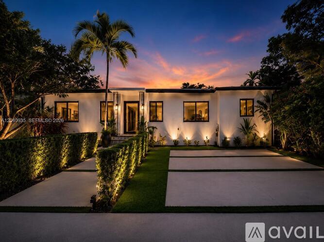 A modern house with a well-manicured lawn and hedges is available for sale.