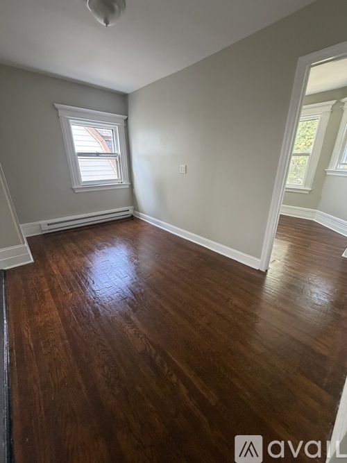 A room with wooden floors and a window.