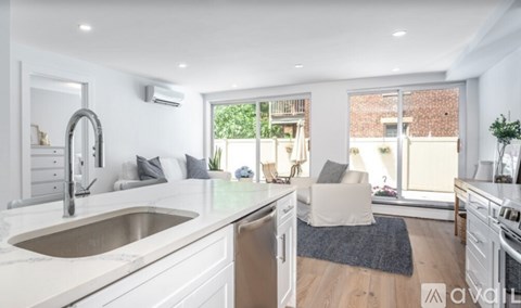 A modern kitchen with a large sink and a window.
