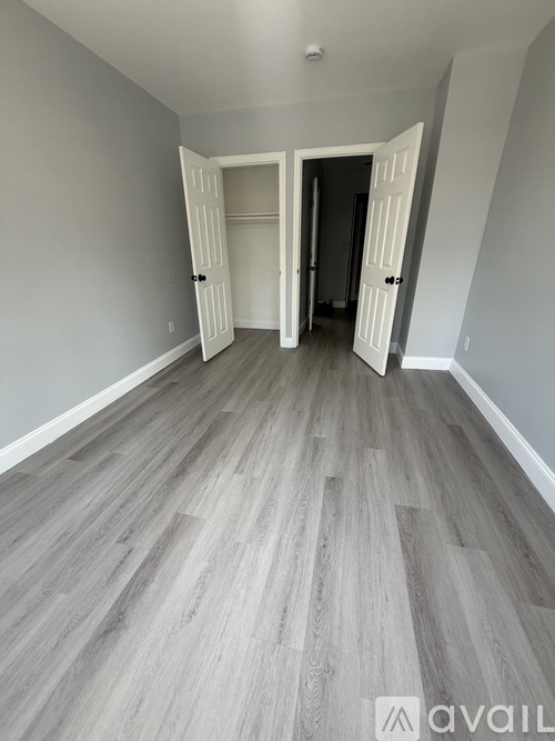 A room with a grey floor and white walls.
