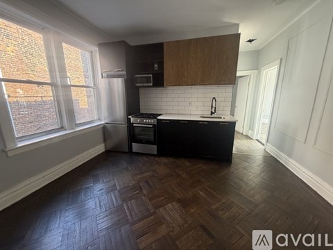 A kitchen with wooden floors and white walls.