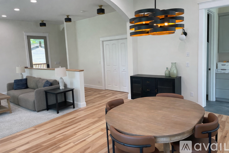 A modern living room with a wooden table and chairs.