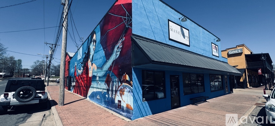 A blue building with a mural on the side and a sign that says "BANK".