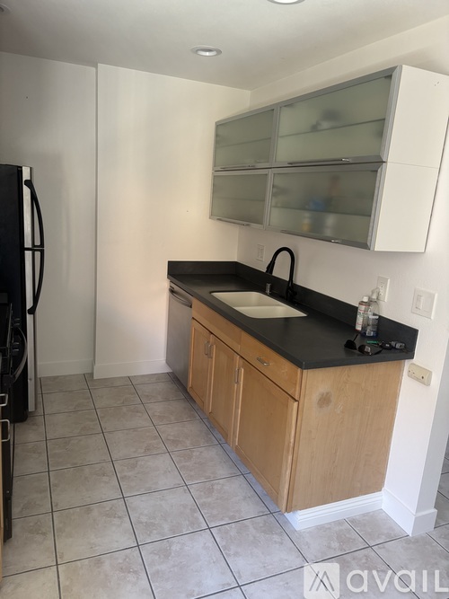 A kitchen with black countertops and white cabinets.
