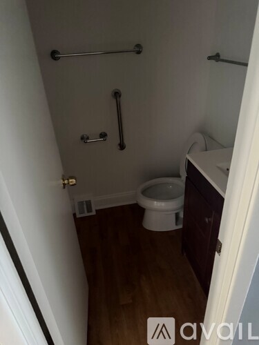 A small bathroom with a toilet and a shower.