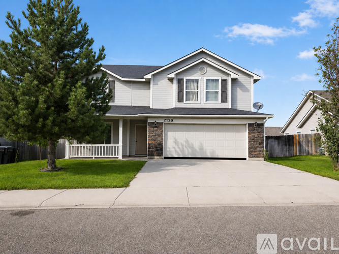 A two-story house with a garage is for sale.