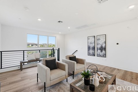 A living room with a glass table and two chairs.
