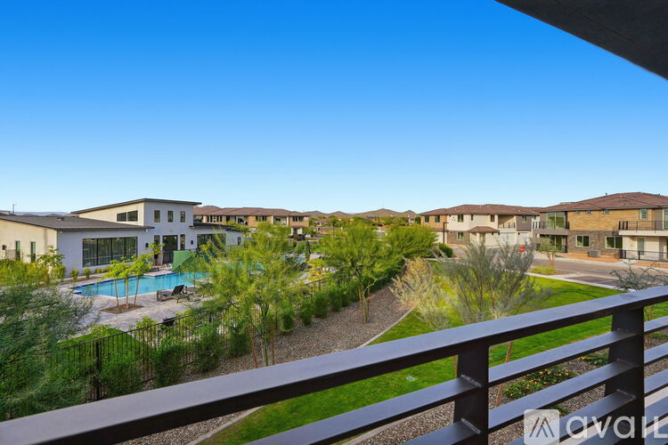 A row of houses with a pool in the foreground.