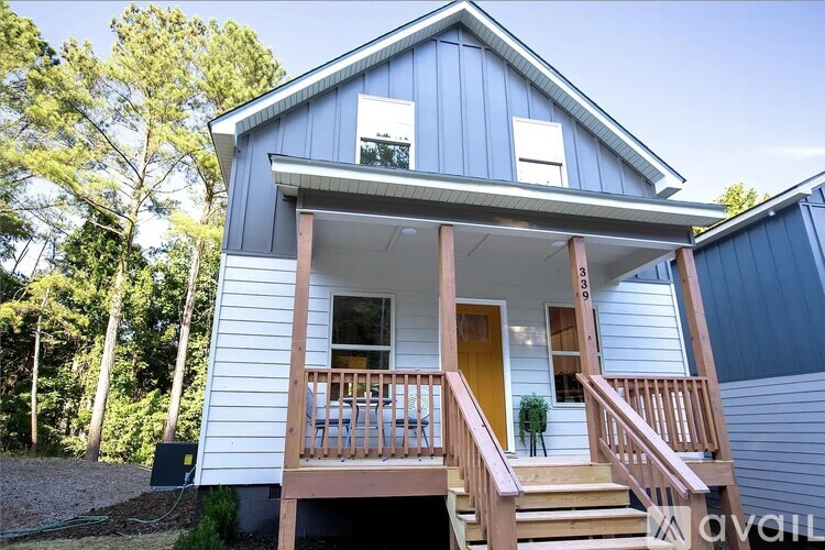 A house with a blue exterior and a brown porch.