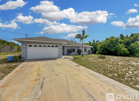 A house with a driveway in front of it is for sale.
