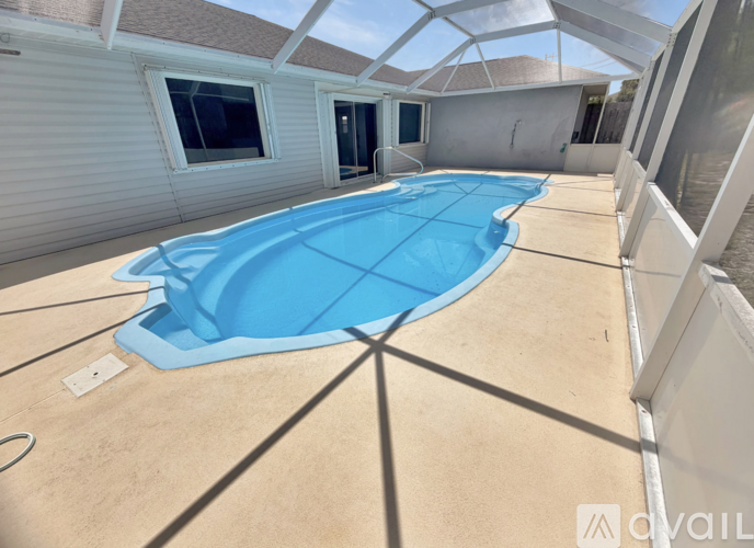 A swimming pool inside a house with a glass ceiling.