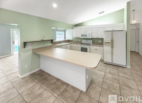A kitchen with a white island in the middle of it.