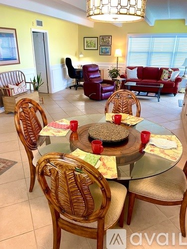 A dining room with a glass table and chairs.