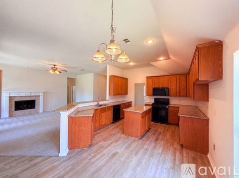 A kitchen with wooden cabinets and a white fireplace.
