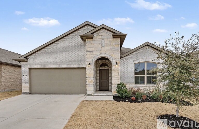 A house with a garage and a driveway is for sale.