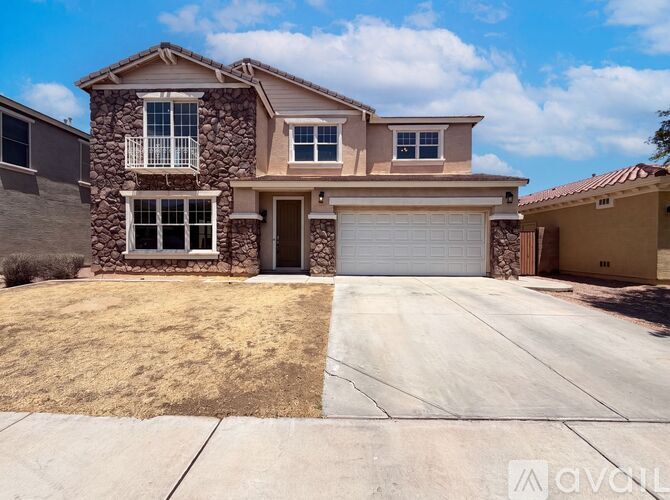 A two-story house with a garage and a driveway.