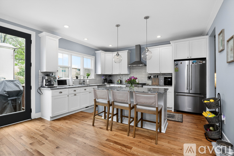 A modern kitchen with a dining table and chairs.