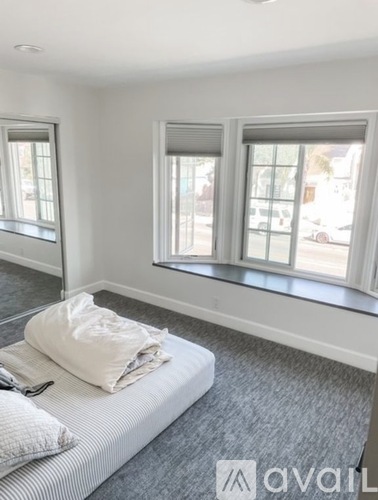 A bedroom with a bed and a window.