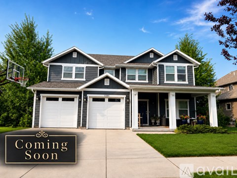 A house with a "Coming Soon" sign in front of it.
