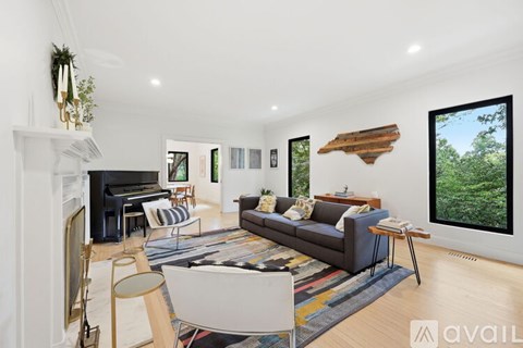 A living room with a grey couch and a fireplace.