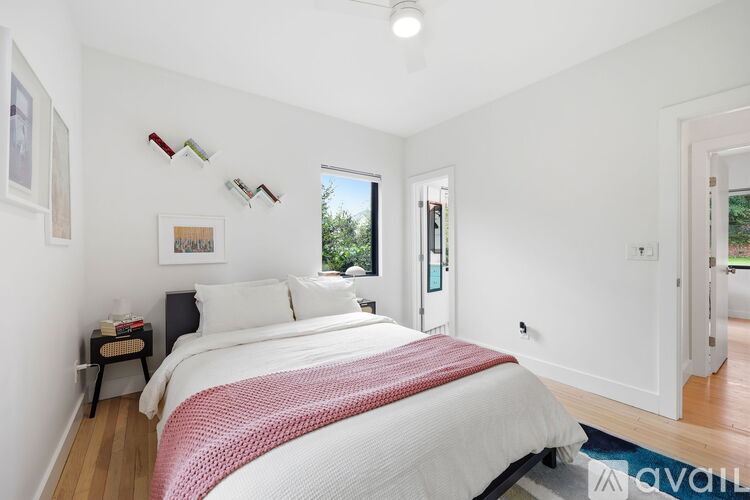 A bedroom with a large bed and a window.