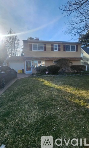 A house with a car parked in front of it.