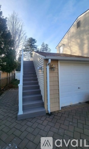 A set of stairs leading up to a garage door.