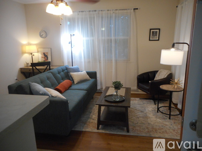 A living room with a blue couch and a coffee table.