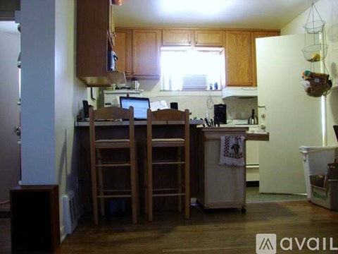 A kitchen with wooden cabinets and a white fridge.