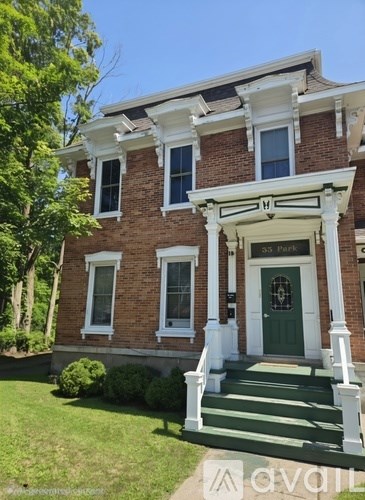 A house with a green front door and white trim.
