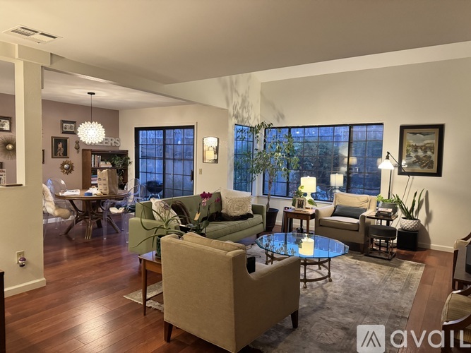A living room with a couch, chairs, and a coffee table.