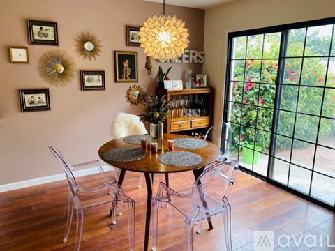 A dining room with a round table and chairs.