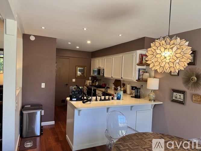 A kitchen with brown walls and a white counter.