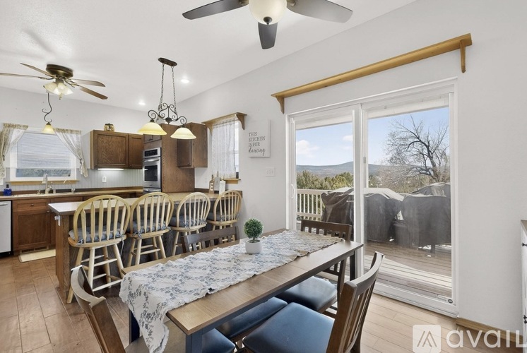 A kitchen with a dining table and chairs is shown.