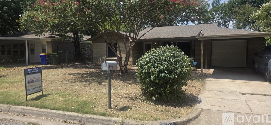 A house with a yard has a sign that says "available".