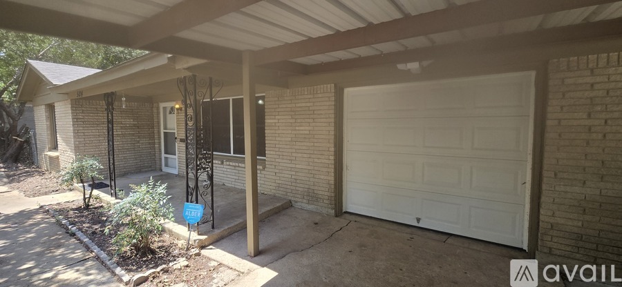 A house with a white garage door and a blue mailbox.
