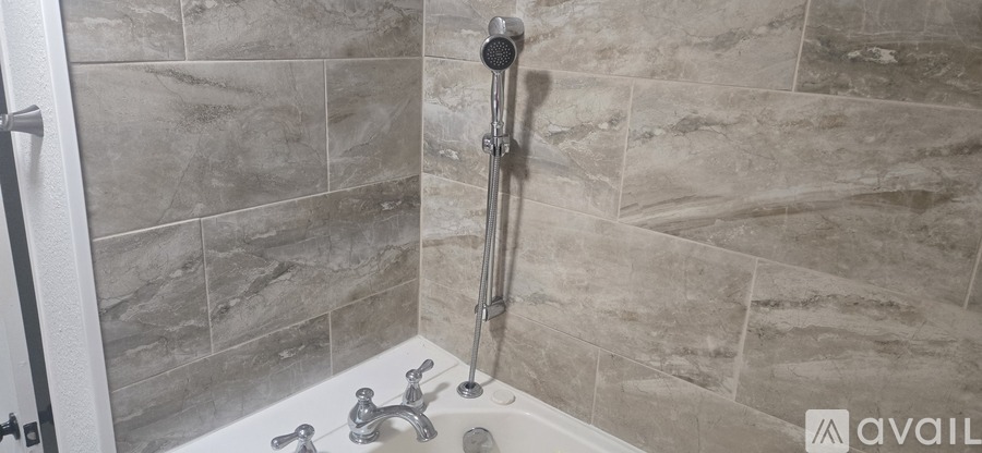A bathroom with a tiled shower and a tub.
