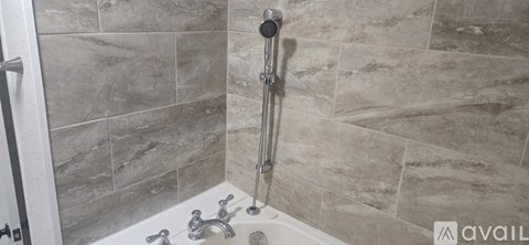 A bathroom with a tiled shower and a tub.