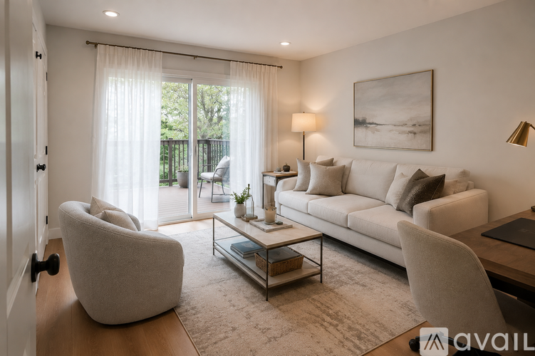 A living room with a sofa, armchair, and coffee table.
