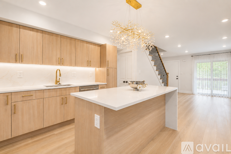 A modern kitchen with wooden cabinets and a white countertop.