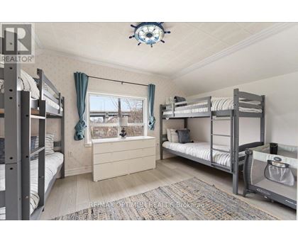 A bedroom with bunk beds and a window.