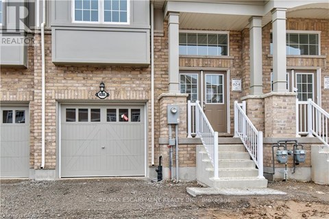 A house with a garage and a staircase leading to the entrance.