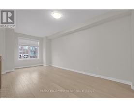 A room with a window and wooden flooring.