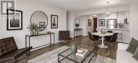 A living room with a brown leather couch and a glass coffee table.