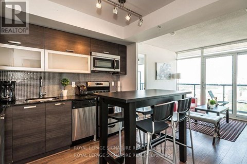 A modern kitchen with a dining table and chairs.