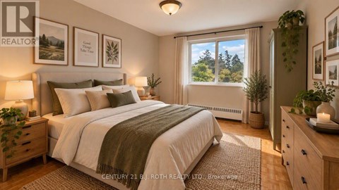 A well-lit bedroom with a large bed and a view of trees outside the window.