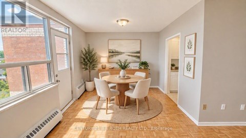 A dining room with a table and chairs.
