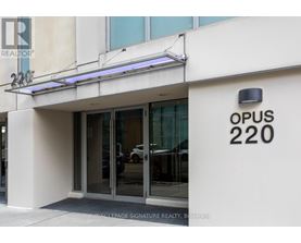 The entrance to a building with the sign OPUS 220.