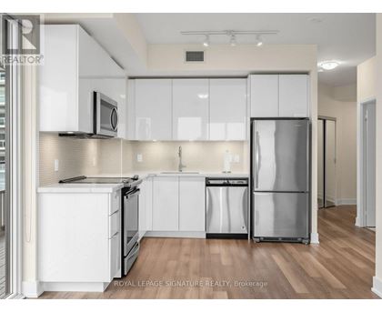 A kitchen with white cabinets and stainless steel appliances.